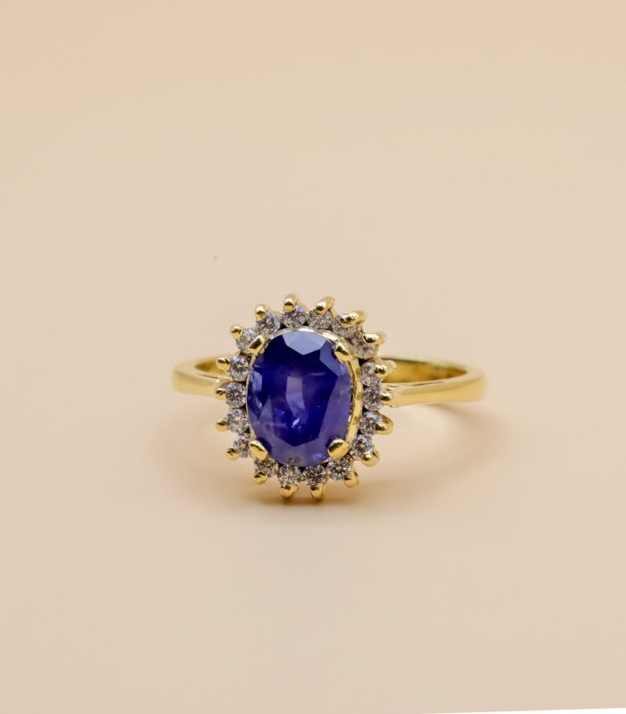 Gold-plated blue sapphire ring with cluster setting, surrounded by sparkling American diamonds, elegant gemstone ring for women, luxury sapphire jewelry online
